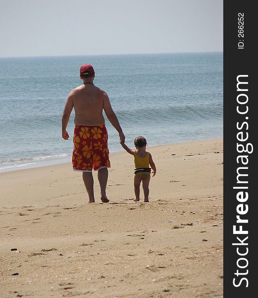 Father And Daughter Walking On Beach