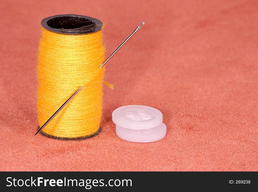 Needle with thread and buttons. Needle with thread and buttons.
