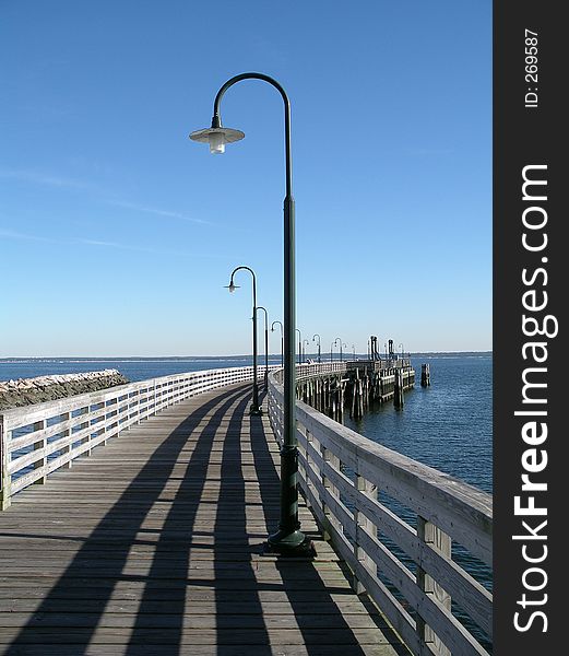 An old wooden pier going out to the ocean. An old wooden pier going out to the ocean