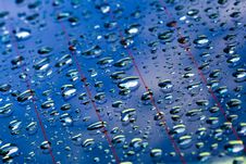 Water Droplets In Blue Surface Stock Image