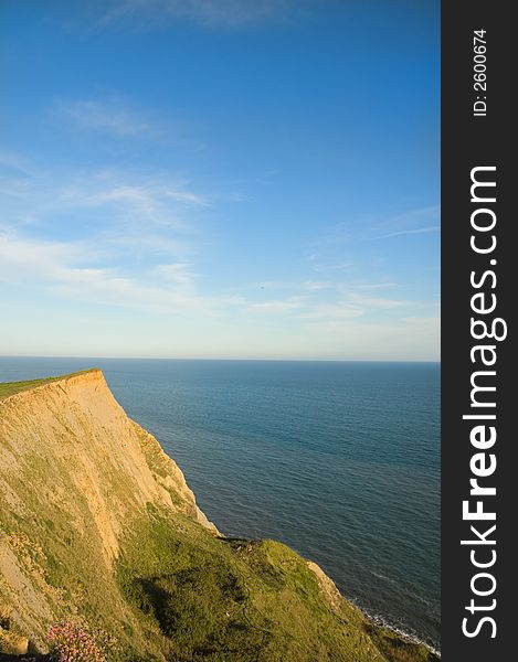View of the cliffs and the English Channel from the coast of Dorset as the sun sets