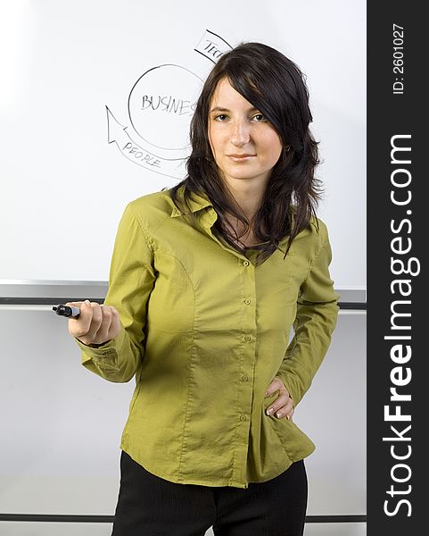 Beauty businesswoman standing in front of blackboard. Giving somebody the marker. Gray background. Beauty businesswoman standing in front of blackboard. Giving somebody the marker. Gray background