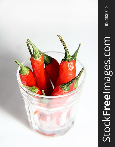 Bunch of red hot chilli pepper in a small glass. Bunch of red hot chilli pepper in a small glass