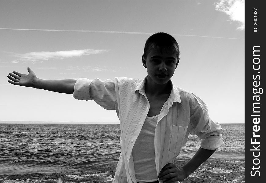 The boy in a white shirt on coast of Baikal. The boy in a white shirt on coast of Baikal
