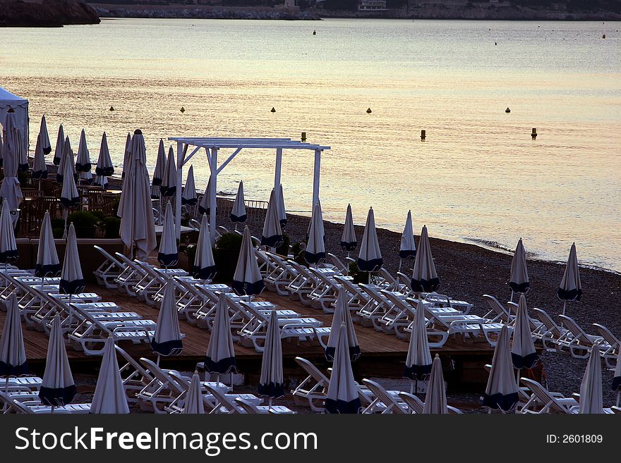 Beach front chairs on the ocean in Nice at sunrise. Beach front chairs on the ocean in Nice at sunrise