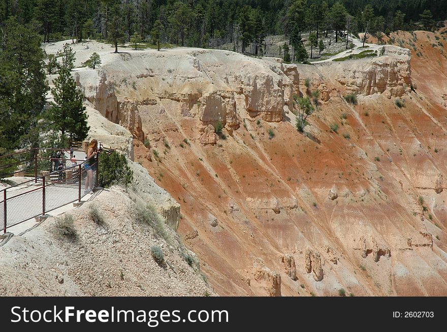 A girl enjoys the canyon view at Bryce Canyon National Park. A girl enjoys the canyon view at Bryce Canyon National Park.