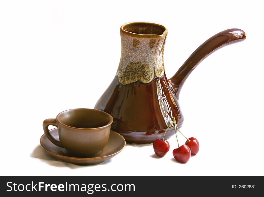 Ceramic cezve, coffee cup and cherries over white