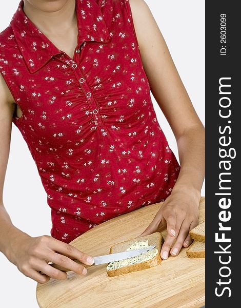 Woman buttering slice of bread