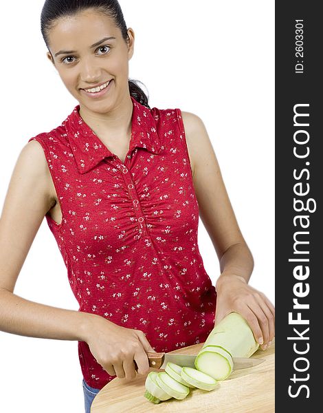 Girl cutting vegetable marrow on wood