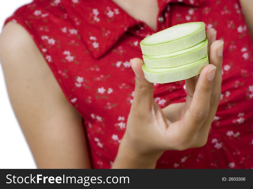 Girl holding pieces of vegetable marrow