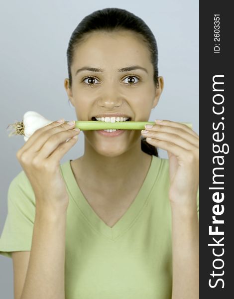 Girl holding garlic in her mouth. Girl holding garlic in her mouth