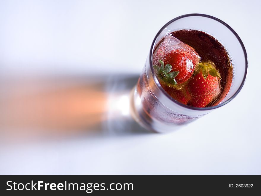 Strawberry and ice cubes in a glass. Strawberry and ice cubes in a glass