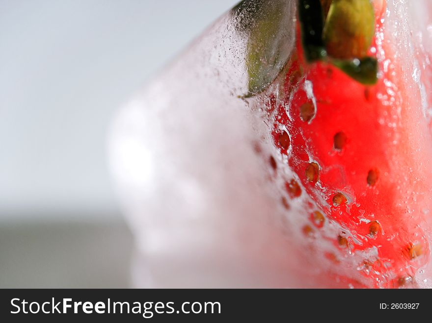 Frozen strawberry in an ice cube. Frozen strawberry in an ice cube