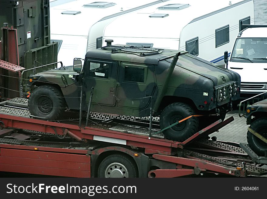 Picture of military truck - Hummer loaded on truck to transport in Kiel port, Germany.