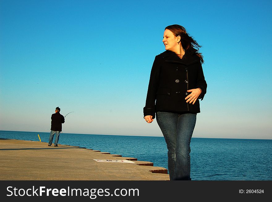 Girl walking on the lake shore. Girl walking on the lake shore