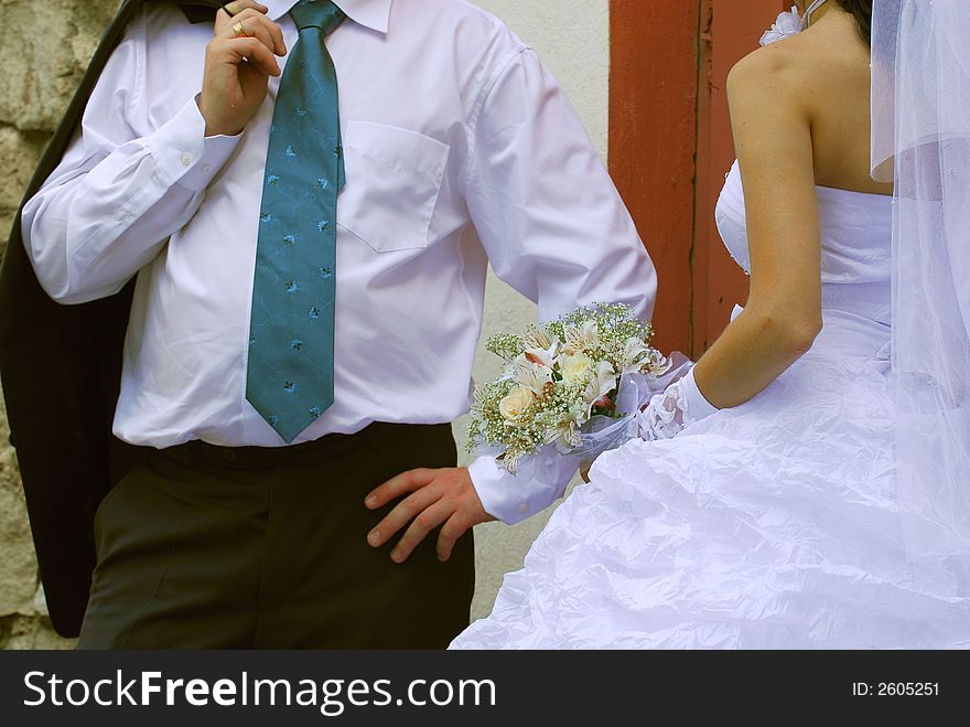 The groom with the bride and a bouquet close up. The groom with the bride and a bouquet close up