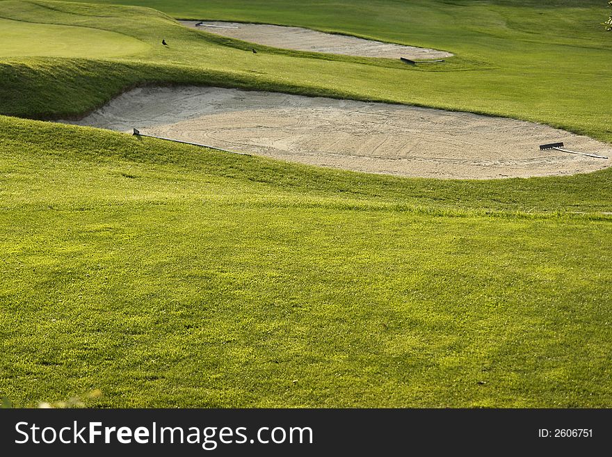 A nice green field for the game of golf. A nice green field for the game of golf