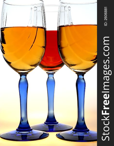 Three blue stemmed decorative wine glasses on white background. Three blue stemmed decorative wine glasses on white background.