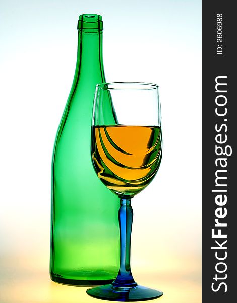 Green bottle and a glass of wine on a white background. Green bottle and a glass of wine on a white background.