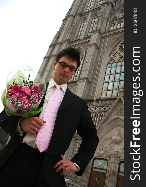 Nervous groom waiting for his bride at church.