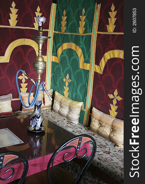 Interior of a Moroccan restaurant with a glass of water on the table - travel and tourism. Interior of a Moroccan restaurant with a glass of water on the table - travel and tourism.