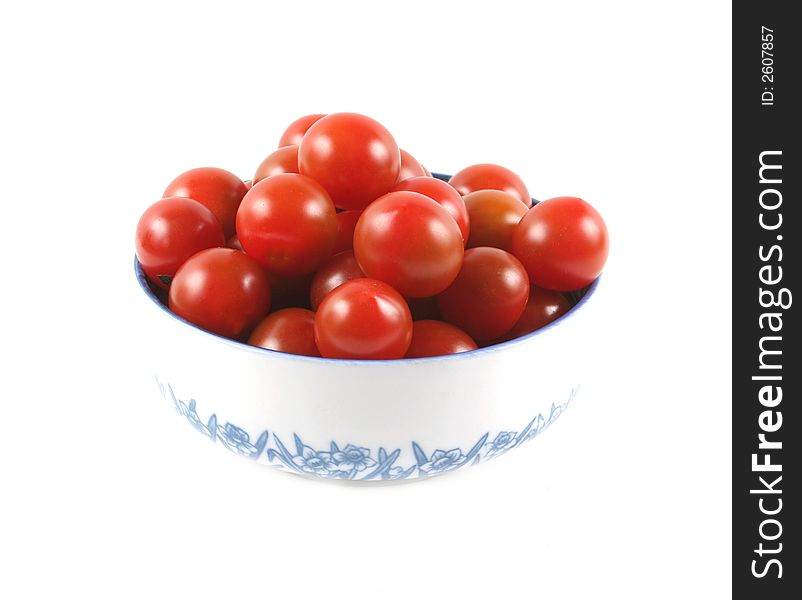 Cherry tomatoes in a bowl isolated on white.