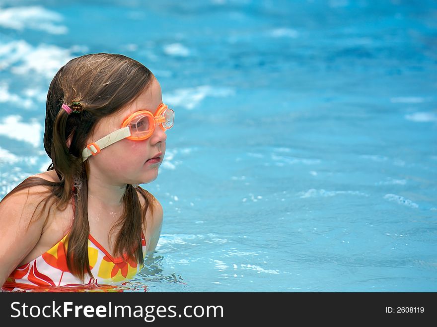 Young girl in swimming pool, wearing goggles. Young girl in swimming pool, wearing goggles