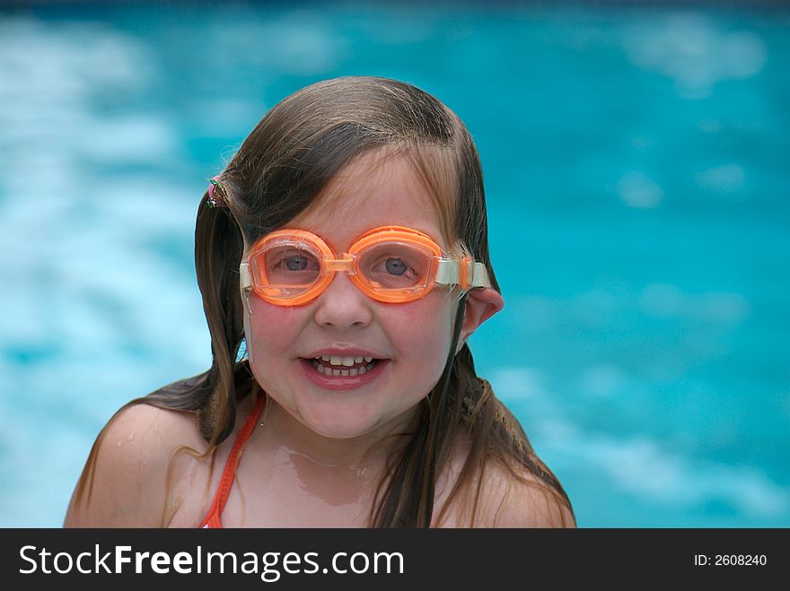 Young girl in swimming pool, wearing goggles. Young girl in swimming pool, wearing goggles