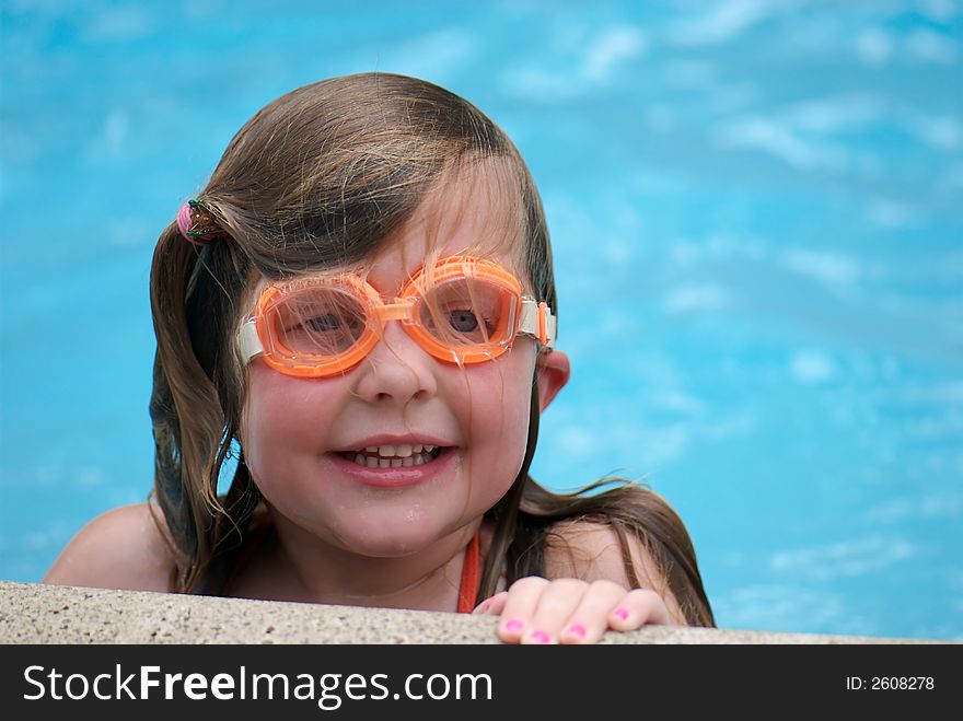 Young girl in swimming pool, wearing goggles. Young girl in swimming pool, wearing goggles