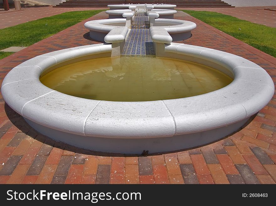 Line of flat round fountains on the beautiful area. Line of flat round fountains on the beautiful area