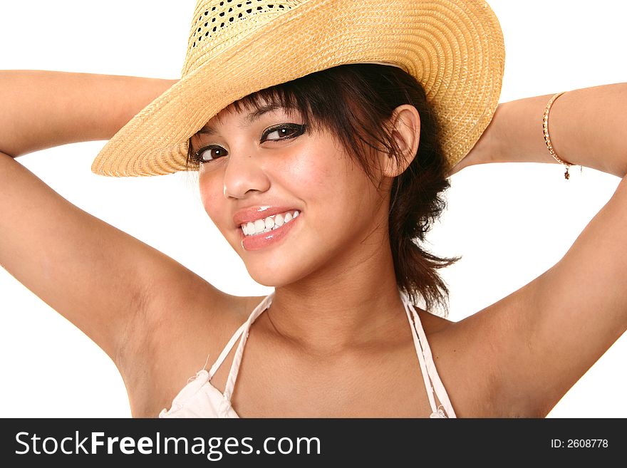 Beautiful brunette wearing straw hat with her hand on her back. isolated on white