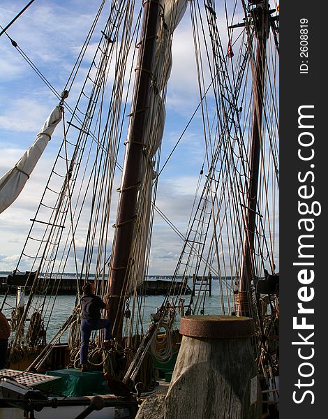 Man adjusting ropes on sailing ship during regatta. Man adjusting ropes on sailing ship during regatta