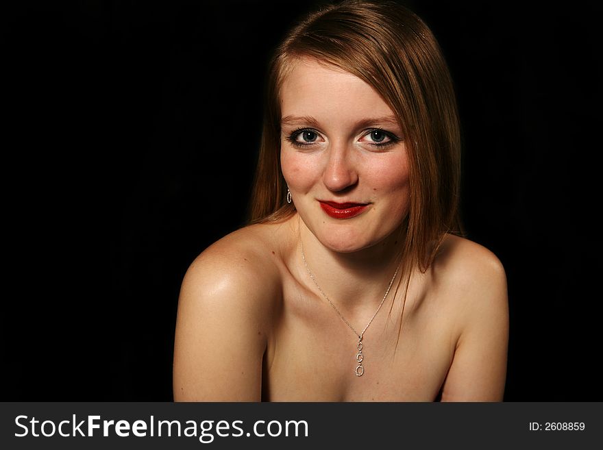 Beautiful blond woman smiling on a black background. Beautiful blond woman smiling on a black background