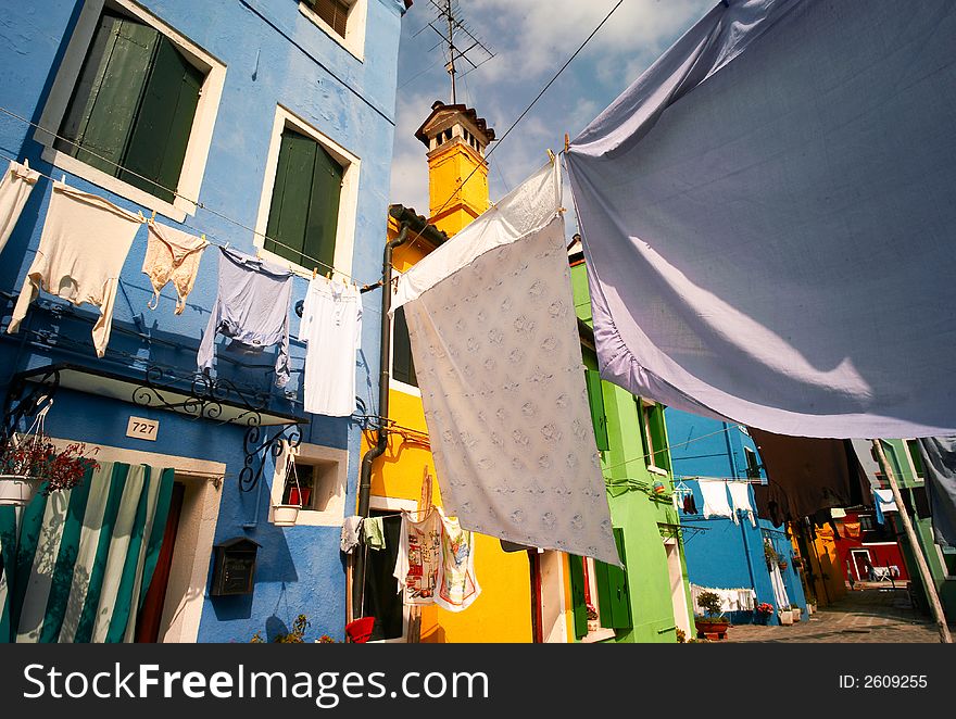 Street of burano in venice with colored houses