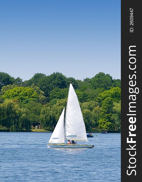 Lonely sailor on his yacht on the lake