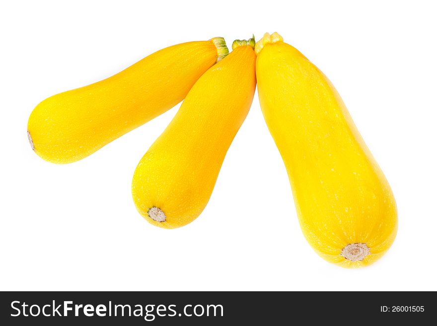 Three golden yellow zucchini isolated on white