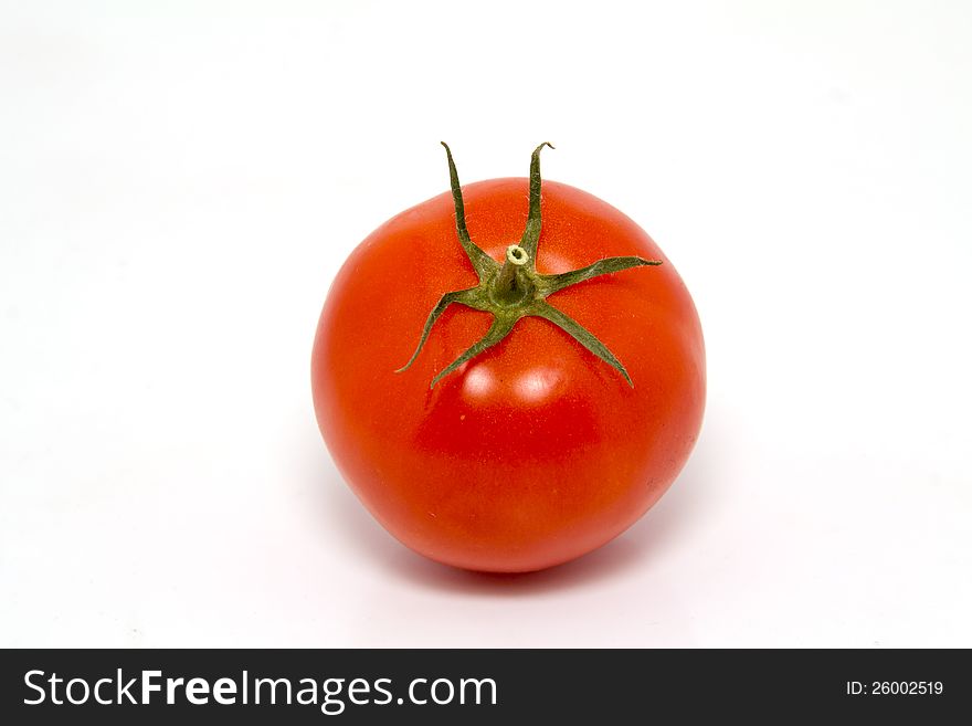 Single fresh red tomato isolated on white