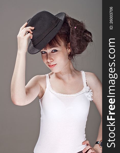 Portrait of a beautiful shy girl with freckles and black hat. Portrait of a beautiful shy girl with freckles and black hat