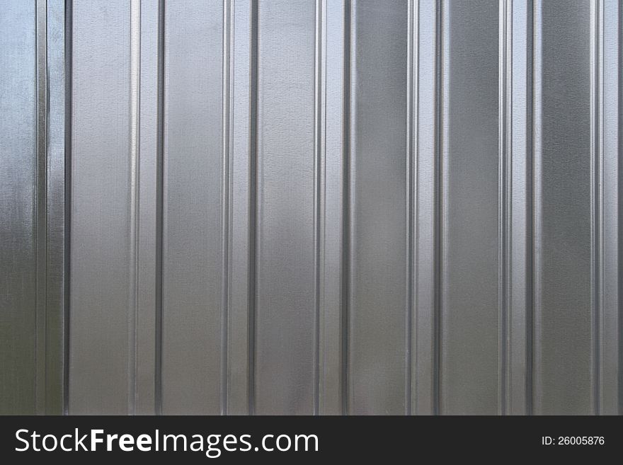 Photo of gray corrugated metal texture with horizontal strips.