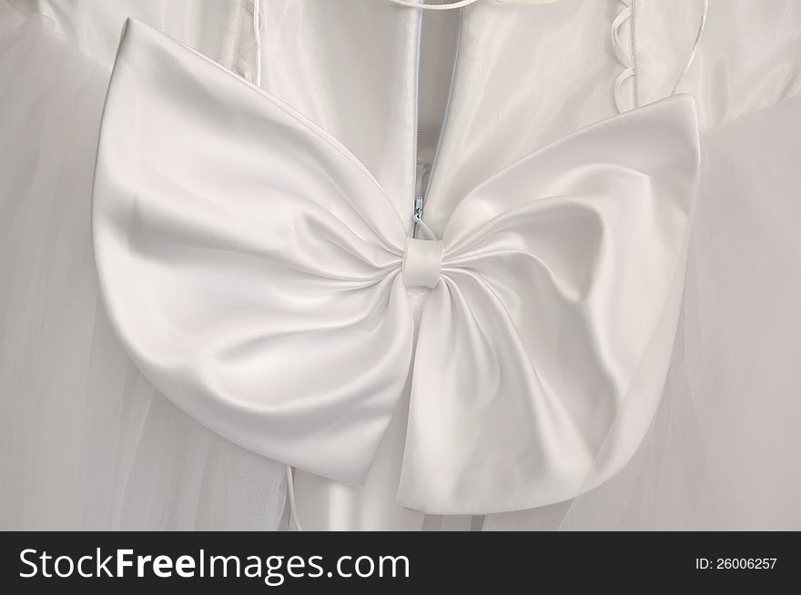White bow as ornament of a wedding dress