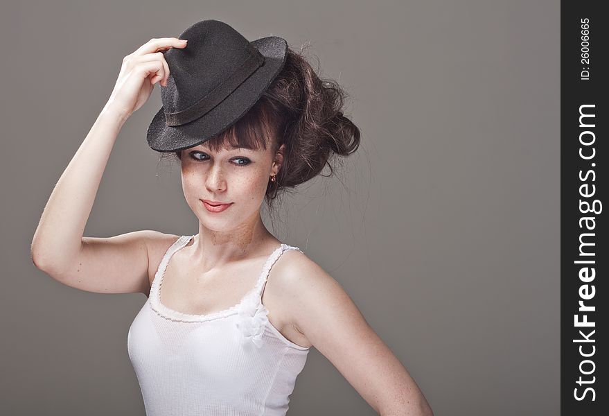 Portrait of a beautiful shy girl with freckles and black hat. Portrait of a beautiful shy girl with freckles and black hat