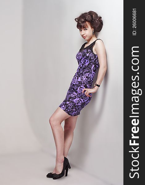 Beautiful girl posing in a violet dress. Beautiful girl posing in a violet dress