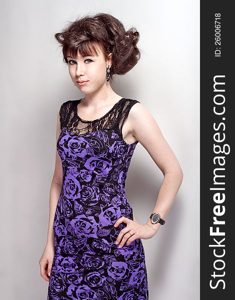 Beautiful girl posing in a violet dress. Beautiful girl posing in a violet dress