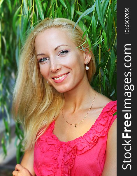 Portrait of young pretty blond woman outdoors