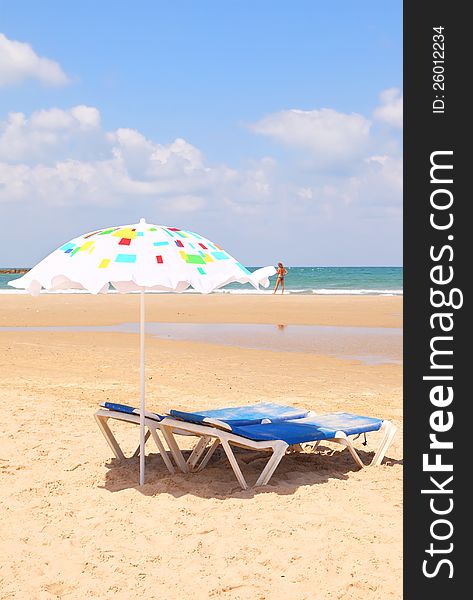 Colorful umbrellas on Mediterranean sandy sea beach