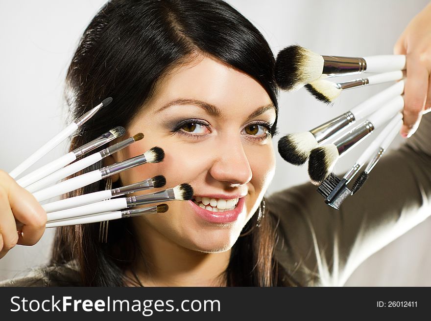 Beautiful Woman With Makeup Brushes