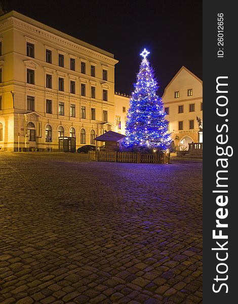 Blue Christmas tree with star on the square at night