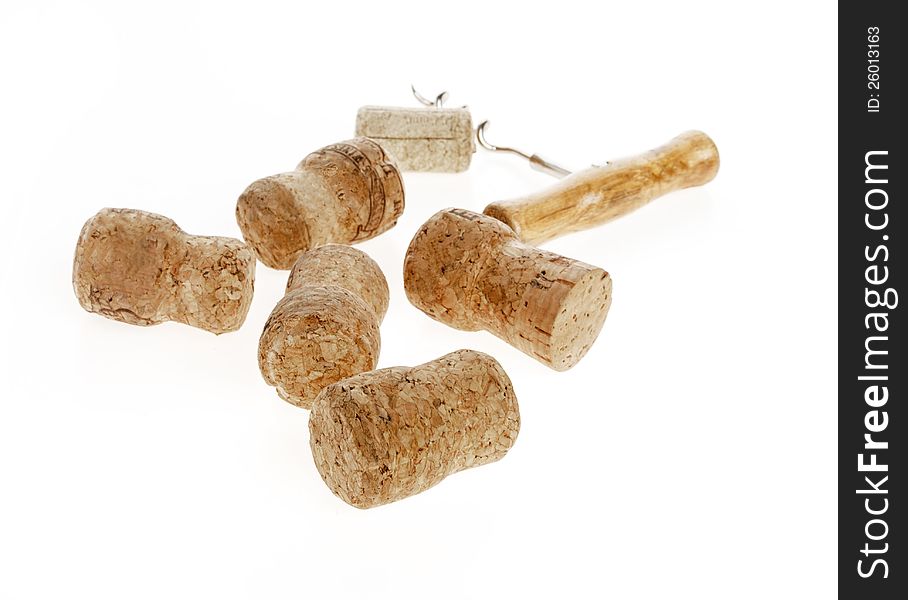 Wine corks and a corkscrew separately on a white