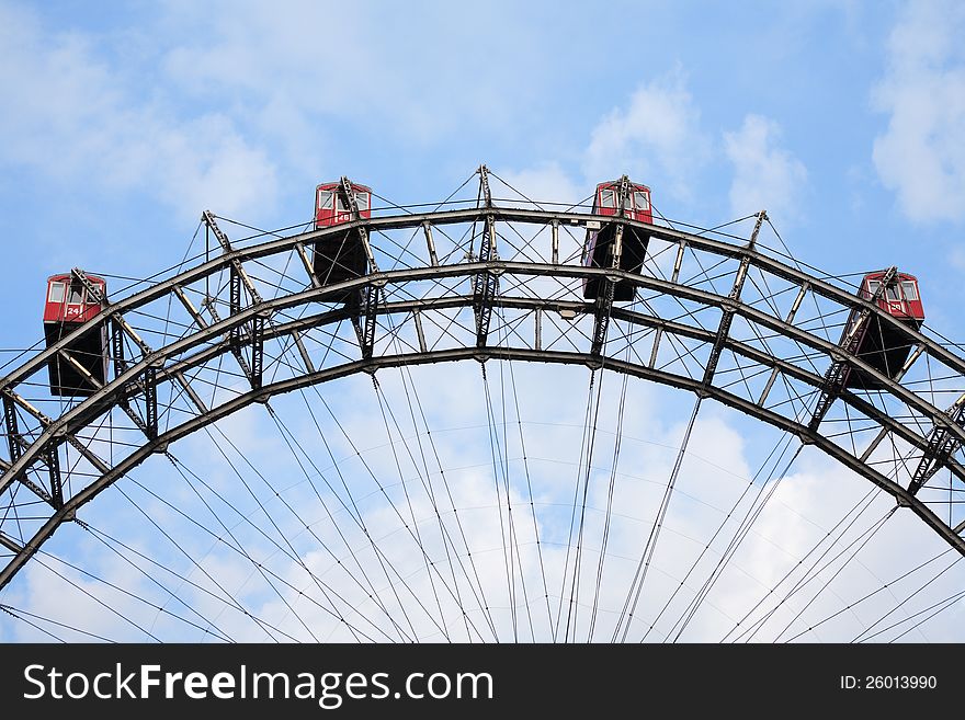 Closeup of famous Ferris wheel against blue sky with clouds in Prater Park, Vienna, Austria