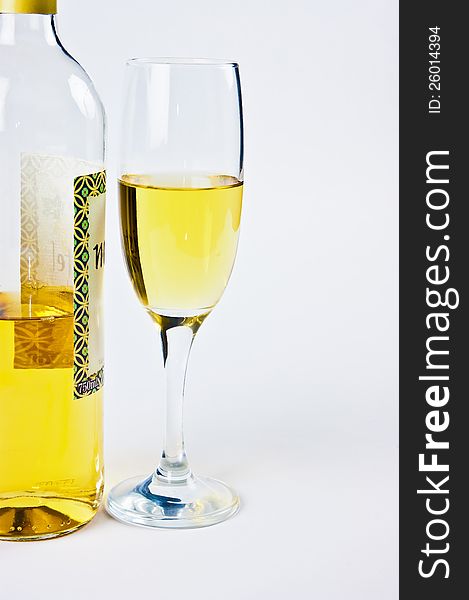 Bottle with a glass of white wine were photographed on a white background